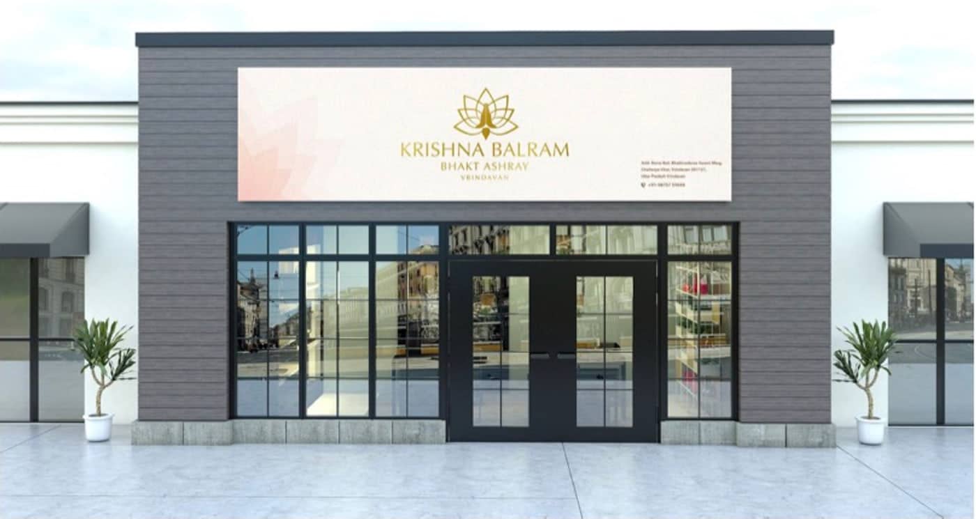 The ashray frontage with a lit signboard carrying the lotus mark and the Raman Reti address